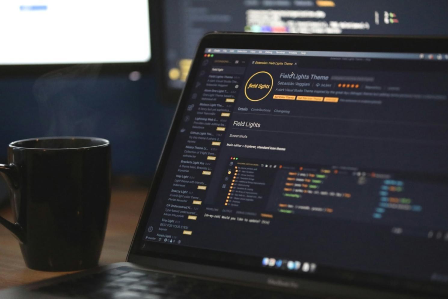 Students collaborating on front-end development projects in modern classroom environment